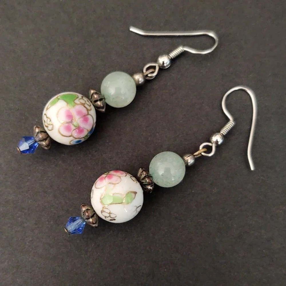 Floral painted ceramic beaded earrings with green and blue bead accents